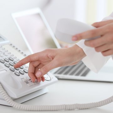 dialing on white phone voip service laptop 1-voip residential